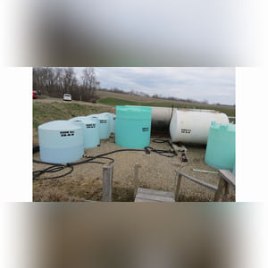 Several flat-bottom poly tanks, 1,550, 2,500 & 6,000 gal.