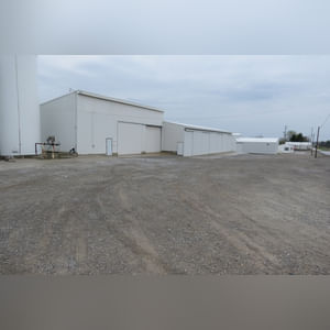 This 42â??x58â?? building is attached to the west end of Building B.  It includes a small office area, concrete floor, (2) 15â??x17â?? sliders, walk-in door, and 220 amp single-phase & 3-phase electric.