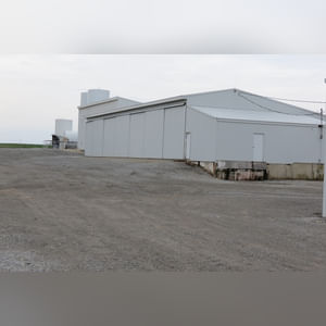 This 42â??x58â?? building is attached to the west end of Building B.  It includes a small office area, concrete floor, (2) 15â??x17â?? sliders, walk-in door, and 220 amp single-phase & 3-phase electric.