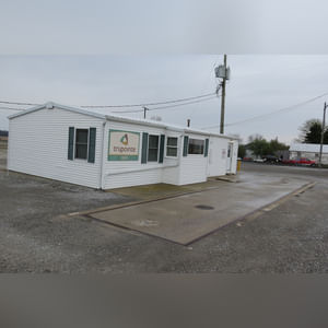 This office building with nearly 1,100 sq. ft. and a full, poured-wall basement, has a natural gas air-forced furnace and central air.  This building offers a very nice floor plan which includes 10â??x10â??, 15â??x8â??, and 12â??x7â?? offices, a 12â??x6â?? file room, a large lobby area, and a restroom.  In addition, the 9.5â??x60â?? in-ground truck scale with a 120,000 lb. capacity is located immediately in front of this building complete with a UMC 465 digital scale display.