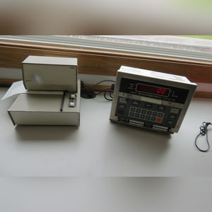 This office building with nearly 1,100 sq. ft. and a full, poured-wall basement, has a natural gas air-forced furnace and central air.  This building offers a very nice floor plan which includes 10â??x10â??, 15â??x8â??, and 12â??x7â?? offices, a 12â??x6â?? file room, a large lobby area, and a restroom.  In addition, the 9.5â??x60â?? in-ground truck scale with a 120,000 lb. capacity is located immediately in front of this building complete with a UMC 465 digital scale display.