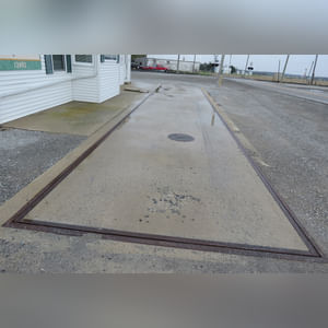 This office building with nearly 1,100 sq. ft. and a full, poured-wall basement, has a natural gas air-forced furnace and central air.  This building offers a very nice floor plan which includes 10â??x10â??, 15â??x8â??, and 12â??x7â?? offices, a 12â??x6â?? file room, a large lobby area, and a restroom.  In addition, the 9.5â??x60â?? in-ground truck scale with a 120,000 lb. capacity is located immediately in front of this building complete with a UMC 465 digital scale display.