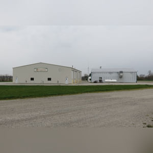 This steel-framed, completely insulated building boasts many custom features making it ideal for multiple purposes.  It includes (3) office areas with built-in work surfaces, air conditioning, and LP gas forced-air heat. (2 offices are 12â??x11â?? & the other is 19â??x11â??.)  The garage/shop area is 75â??x100â?? with concrete floors & approaches, (6) 16â??x16â?? overhead doors with openers, (4) walk-in doors, and loft storage area above offices.  Additional amenities include (2) Reznor LP heaters, Energylogic waste oil furnace, ventilation system with louvered panels, ceiling fans, multiple electrical panels with 220 amp service, several outdoor electrical outlets with pigtail cords to plug in tractors, semis, etc., and a 10 HP 2-stage NAPA air compressor.