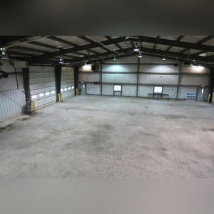 This steel-framed, completely insulated building boasts many custom features making it ideal for multiple purposes.  It includes (3) office areas with built-in work surfaces, air conditioning, and LP gas forced-air heat. (2 offices are 12â??x11â?? & the other is 19â??x11â??.)  The garage/shop area is 75â??x100â?? with concrete floors & approaches, (6) 16â??x16â?? overhead doors with openers, (4) walk-in doors, and loft storage area above offices.  Additional amenities include (2) Reznor LP heaters, Energylogic waste oil furnace, ventilation system with louvered panels, ceiling fans, multiple electrical panels with 220 amp service, several outdoor electrical outlets with pigtail cords to plug in tractors, semis, etc., and a 10 HP 2-stage NAPA air compressor.