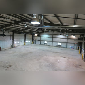 This steel-framed, completely insulated building boasts many custom features making it ideal for multiple purposes.  It includes (3) office areas with built-in work surfaces, air conditioning, and LP gas forced-air heat. (2 offices are 12â??x11â?? & the other is 19â??x11â??.)  The garage/shop area is 75â??x100â?? with concrete floors & approaches, (6) 16â??x16â?? overhead doors with openers, (4) walk-in doors, and loft storage area above offices.  Additional amenities include (2) Reznor LP heaters, Energylogic waste oil furnace, ventilation system with louvered panels, ceiling fans, multiple electrical panels with 220 amp service, several outdoor electrical outlets with pigtail cords to plug in tractors, semis, etc., and a 10 HP 2-stage NAPA air compressor.