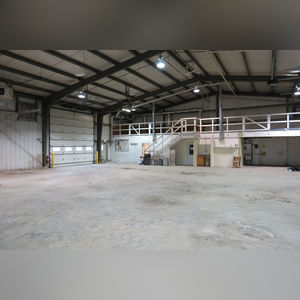 This steel-framed, completely insulated building boasts many custom features making it ideal for multiple purposes.  It includes (3) office areas with built-in work surfaces, air conditioning, and LP gas forced-air heat. (2 offices are 12â??x11â?? & the other is 19â??x11â??.)  The garage/shop area is 75â??x100â?? with concrete floors & approaches, (6) 16â??x16â?? overhead doors with openers, (4) walk-in doors, and loft storage area above offices.  Additional amenities include (2) Reznor LP heaters, Energylogic waste oil furnace, ventilation system with louvered panels, ceiling fans, multiple electrical panels with 220 amp service, several outdoor electrical outlets with pigtail cords to plug in tractors, semis, etc., and a 10 HP 2-stage NAPA air compressor.