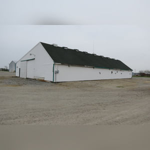 This drive-thru storage building is 60â??x105â?? with concrete floors, a front office area, a newer shingled roof, and 480 amp service.  There are (8) 11â??x32â?? individual storage bays, (2) end-sliders, and (2) walk-in doors.