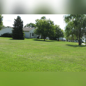 10± acres, home, pole barn, shop building, fenced pastures, and pond. The impressive interior of the home boasts 4 bedrooms and 3 full baths. The master suite is 16â??x16â?? with a large walk-in closet. The master bath has a double sink and a large custom shower. The 22â??x14â?? eat-in kitchen has custom cabinets, granite counter tops, and a brick-front raised fireplace. The large main level also includes the 20â??x14â?? living room with fireplace, 18â??x16â?? family room, 14â??x12â?? office area, mud room, and laundry room. This spacious main level floor plan is ideal for the family as well as entertaining. The full basement is partially finished, and the 2-car attached garage includes a large storage area. Other amenities within the home include a Lennox LP gas forced-air furnace, central air, Pella windows, a newer roof, cathedral ceilings, ceramic tile and wood flooring, ceiling fans, and a Radionon system. The exterior is beautifully landscaped with mature trees, colorful perennials, a small orchard and grape vineyard, a large play area, and a ½ acre stocked pond. The 60â??x50â?? pole barn with walk-in door and 14â??-high end slider includes grooved concrete, maternity pens, custom Gingway gates, a working chute, and 4 individual turn-out pens. There are 6 fenced and cross-fenced pasture areas, each with its own Ritchie waterer. The 34â??x32â?? shop building has a concrete floor, porch, and walk-in and overhead doors.