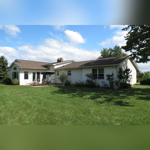 10± acres, home, pole barn, shop building, fenced pastures, and pond. The impressive interior of the home boasts 4 bedrooms and 3 full baths. The master suite is 16â??x16â?? with a large walk-in closet. The master bath has a double sink and a large custom shower. The 22â??x14â?? eat-in kitchen has custom cabinets, granite counter tops, and a brick-front raised fireplace. The large main level also includes the 20â??x14â?? living room with fireplace, 18â??x16â?? family room, 14â??x12â?? office area, mud room, and laundry room. This spacious main level floor plan is ideal for the family as well as entertaining. The full basement is partially finished, and the 2-car attached garage includes a large storage area. Other amenities within the home include a Lennox LP gas forced-air furnace, central air, Pella windows, a newer roof, cathedral ceilings, ceramic tile and wood flooring, ceiling fans, and a Radionon system. The exterior is beautifully landscaped with mature trees, colorful perennials, a small orchard and grape vineyard, a large play area, and a ½ acre stocked pond. The 60â??x50â?? pole barn with walk-in door and 14â??-high end slider includes grooved concrete, maternity pens, custom Gingway gates, a working chute, and 4 individual turn-out pens. There are 6 fenced and cross-fenced pasture areas, each with its own Ritchie waterer. The 34â??x32â?? shop building has a concrete floor, porch, and walk-in and overhead doors.