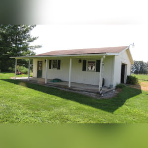 10± acres, home, pole barn, shop building, fenced pastures, and pond. The impressive interior of the home boasts 4 bedrooms and 3 full baths. The master suite is 16â??x16â?? with a large walk-in closet. The master bath has a double sink and a large custom shower. The 22â??x14â?? eat-in kitchen has custom cabinets, granite counter tops, and a brick-front raised fireplace. The large main level also includes the 20â??x14â?? living room with fireplace, 18â??x16â?? family room, 14â??x12â?? office area, mud room, and laundry room. This spacious main level floor plan is ideal for the family as well as entertaining. The full basement is partially finished, and the 2-car attached garage includes a large storage area. Other amenities within the home include a Lennox LP gas forced-air furnace, central air, Pella windows, a newer roof, cathedral ceilings, ceramic tile and wood flooring, ceiling fans, and a Radionon system. The exterior is beautifully landscaped with mature trees, colorful perennials, a small orchard and grape vineyard, a large play area, and a ½ acre stocked pond. The 60â??x50â?? pole barn with walk-in door and 14â??-high end slider includes grooved concrete, maternity pens, custom Gingway gates, a working chute, and 4 individual turn-out pens. There are 6 fenced and cross-fenced pasture areas, each with its own Ritchie waterer. The 34â??x32â?? shop building has a concrete floor, porch, and walk-in and overhead doors.