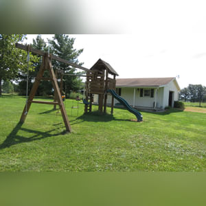 10± acres, home, pole barn, shop building, fenced pastures, and pond. The impressive interior of the home boasts 4 bedrooms and 3 full baths. The master suite is 16â??x16â?? with a large walk-in closet. The master bath has a double sink and a large custom shower. The 22â??x14â?? eat-in kitchen has custom cabinets, granite counter tops, and a brick-front raised fireplace. The large main level also includes the 20â??x14â?? living room with fireplace, 18â??x16â?? family room, 14â??x12â?? office area, mud room, and laundry room. This spacious main level floor plan is ideal for the family as well as entertaining. The full basement is partially finished, and the 2-car attached garage includes a large storage area. Other amenities within the home include a Lennox LP gas forced-air furnace, central air, Pella windows, a newer roof, cathedral ceilings, ceramic tile and wood flooring, ceiling fans, and a Radionon system. The exterior is beautifully landscaped with mature trees, colorful perennials, a small orchard and grape vineyard, a large play area, and a ½ acre stocked pond. The 60â??x50â?? pole barn with walk-in door and 14â??-high end slider includes grooved concrete, maternity pens, custom Gingway gates, a working chute, and 4 individual turn-out pens. There are 6 fenced and cross-fenced pasture areas, each with its own Ritchie waterer. The 34â??x32â?? shop building has a concrete floor, porch, and walk-in and overhead doors.