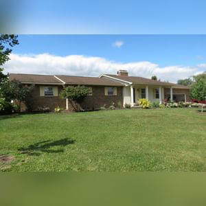 10± acres, home, pole barn, shop building, fenced pastures, and pond. The impressive interior of the home boasts 4 bedrooms and 3 full baths. The master suite is 16â??x16â?? with a large walk-in closet. The master bath has a double sink and a large custom shower. The 22â??x14â?? eat-in kitchen has custom cabinets, granite counter tops, and a brick-front raised fireplace. The large main level also includes the 20â??x14â?? living room with fireplace, 18â??x16â?? family room, 14â??x12â?? office area, mud room, and laundry room. This spacious main level floor plan is ideal for the family as well as entertaining. The full basement is partially finished, and the 2-car attached garage includes a large storage area. Other amenities within the home include a Lennox LP gas forced-air furnace, central air, Pella windows, a newer roof, cathedral ceilings, ceramic tile and wood flooring, ceiling fans, and a Radionon system. The exterior is beautifully landscaped with mature trees, colorful perennials, a small orchard and grape vineyard, a large play area, and a ½ acre stocked pond. The 60â??x50â?? pole barn with walk-in door and 14â??-high end slider includes grooved concrete, maternity pens, custom Gingway gates, a working chute, and 4 individual turn-out pens. There are 6 fenced and cross-fenced pasture areas, each with its own Ritchie waterer. The 34â??x32â?? shop building has a concrete floor, porch, and walk-in and overhead doors.